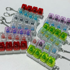 Transparent PC Shaft Tester with Light by Phora'store; multicolor translucent keyboard switch samples on keychains.