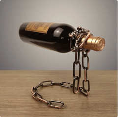Suspension chain wine rack metal holder with copper-toned chain holding a dark wine bottle by the neck