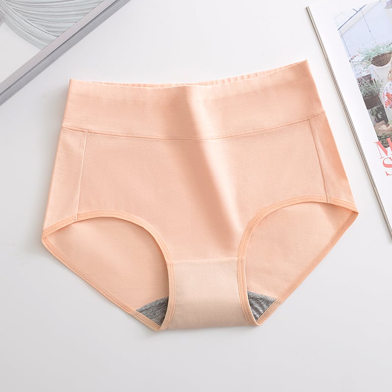 Plus size hip-lifting underwear in peach, high-waisted briefs with full coverage.